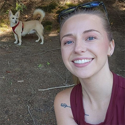 Dental Assistant Tabitha Smiling Outdoors With Dog