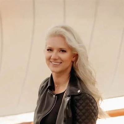 Registered Dental Hygienist Vera Smiling In Leather Jacket